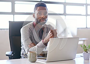 Portrait, black man and technology on desk in office for creative job as web developer or graphic designer for company