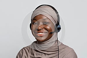 Portrait of black muslim call center operator lady in hijab and headset