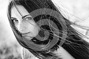 Portrait black and white of a beautiful fashionable young girl with flying hair