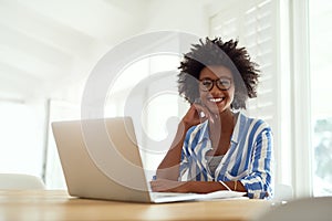 Portrait, black woman and laptop in home with glasses for remote work, online business and entrepreneur. African female