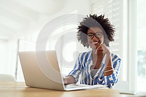 Portrait, black woman and laptop in house with glasses for remote work, online business and entrepreneur. African female