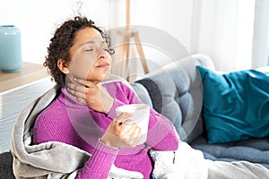 Portrait of black woman suffering tonsillitis at home