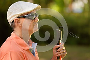 Portrait Of Blind Man Sitting In City Park