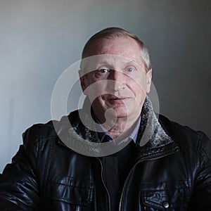 Portrait blond blue-eyed man in black jacket