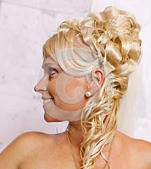 Portrait of blond bride with fashionable coiffure photo