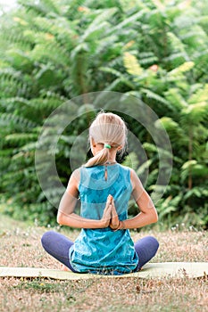 Portrait of Blond caucasian girl in namaste. girl hands in namaste gesture outdoor summer day. yoga, mindfulness, harmony concept