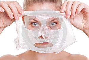 Portrait blond girl in facial mask. Beauty and skin care.