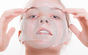 Portrait blond girl in facial mask. Beauty and skin care.