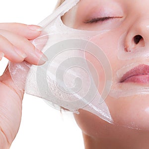 Portrait blond girl in facial mask. Part face. Beauty and skin care.