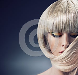 Portrait of a blond lady with trendy coiffure photo