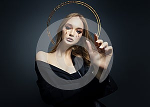 Portrait of blond sexy woman with long hair halo nimbus over her head on black background. Perfect girl with nimb, beautiful eyes