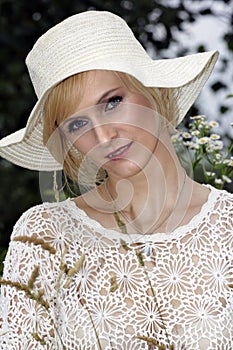 Portrait of blond woman with hat.