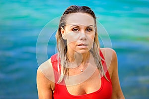 Portrait of a  blond woman in a red swimsuit