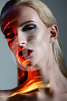 Portrait of a blond Woman with shining lights on face