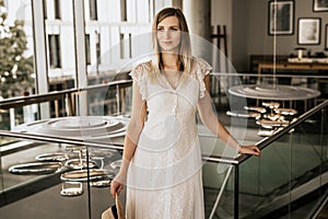 Portrait of blond woman in white dress