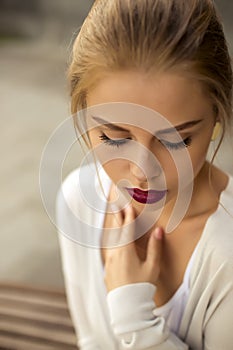 Portrait of blond woman in white dress outdoor