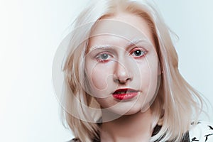 Portrait blonde albino girl in studio on white background