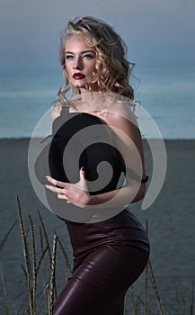 Portrait of a blonde at the evening beach