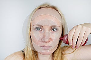 A young woman puts a gel mask on her face. Care for oily, problem skin photo