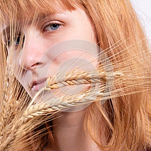 Portrait of a blonde girl with ears of wheat