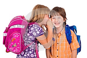 Portrait of a blonde girl whispering in boy's ear