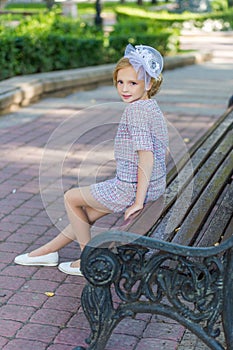 Portrait of a blonde in pink attire in a park outdoors.