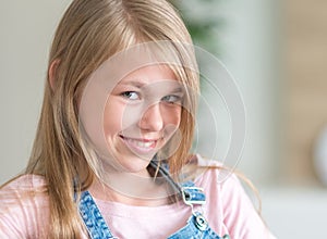 Portrait of blonde pre-Teenage Girl sitting on couch