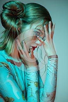 Portrait of blonde woman in blue bodysuit