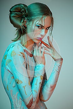 Portrait of blonde woman in blue bodysuit