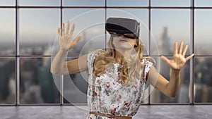 Portrait of a blonde woman in headset experiencing virtual reality.