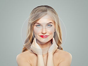 Portrait of blonde woman with healthy hair, clear skin and red lips makeup. Perfect female face