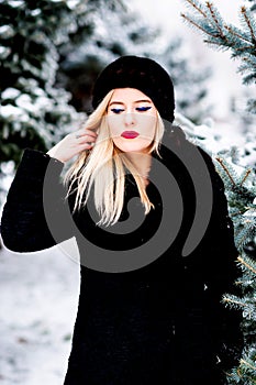 The portrait of blonde woman in mink hat