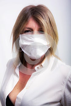 portrait of blonde woman with protection mask, fair complexion dressed in light dress