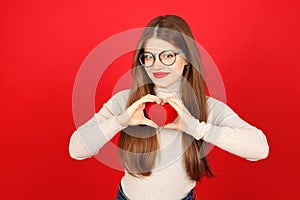 Portrait of a blood donor woman holding a red heart in her hands