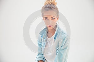 Portrait of a blue eyed blonde in jeans shirt