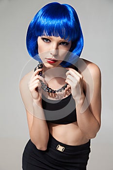 Portrait of blue-haired stylish woman in chain necklace