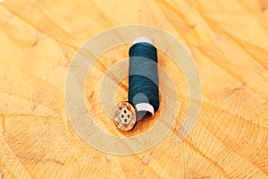 Portrait of blue Sewing thread and button