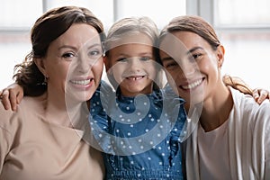 Portrait of bonding mixed race multigenerational female family.