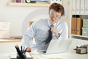 Portrait of bookkeeper or auditor sitting at his workplace photo