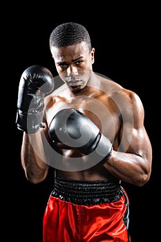 Portrait of boxer performing uppercut