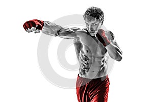 Portrait of boxer who practicing jab on white background. Black and white. Red sportswear