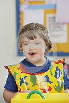 Portrait of boy (5-6) with Down syndrome in kindergarten