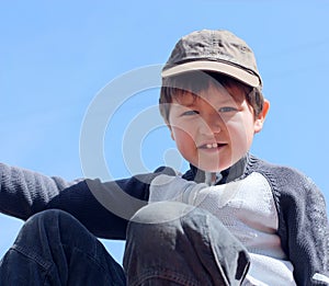 Portrait of a boy 7 years against the blue sky