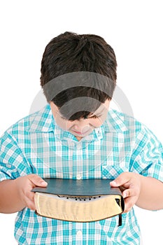 Portrait of a boy with a Bible in hand and prayed