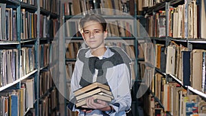 Portrait of a boy with books in the library