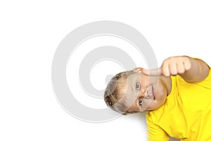 Portrait of a boy in a bright yellow t-shirt with a finger up. Showed class. The child is isolated on a white background.