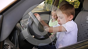Portrait of a boy in a car in the front seat with a lollipop.