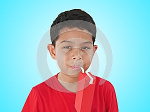 Portrait of Boy Drinking Soy Milk from UHT Box with Straw Isolated on Cyan Background