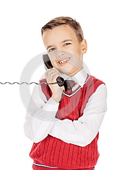 Portrait Boy emotionally talking on the wired telephone on whit