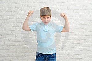 Portrait of a boy of European appearance on a light background, blond boy 9 years old. Funny strong child